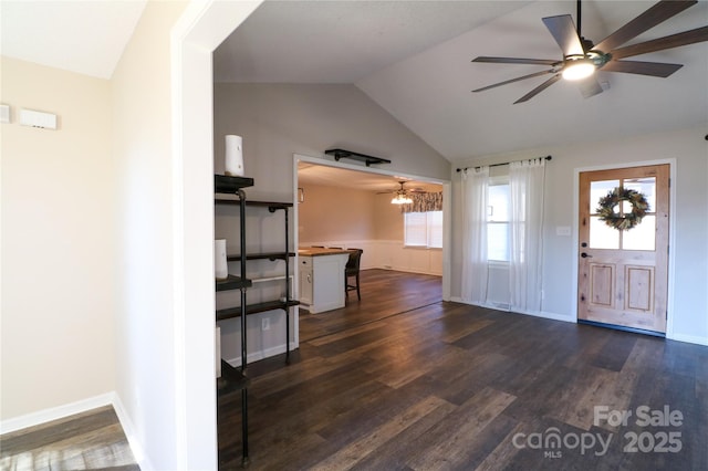 entrance foyer with dark hardwood / wood-style floors, ceiling fan, and lofted ceiling