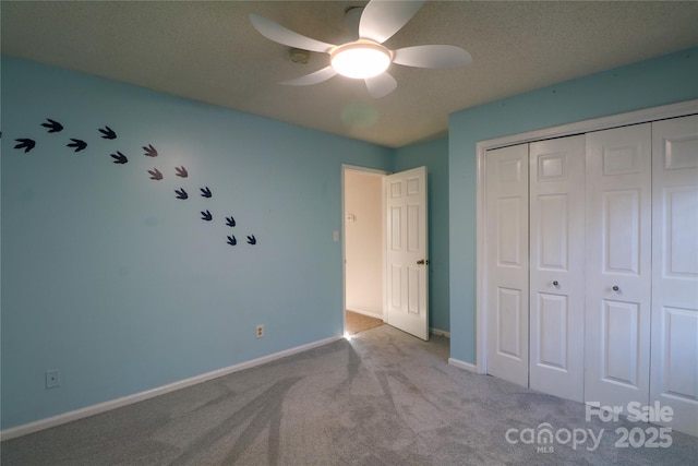 unfurnished bedroom with a closet, ceiling fan, and light colored carpet