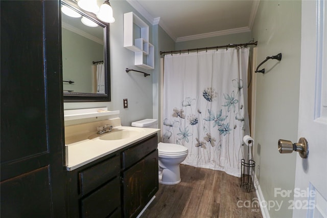 bathroom with a shower with shower curtain, vanity, crown molding, hardwood / wood-style floors, and toilet