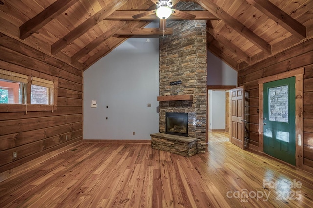 unfurnished living room with wood ceiling, light hardwood / wood-style flooring, high vaulted ceiling, beamed ceiling, and wood walls