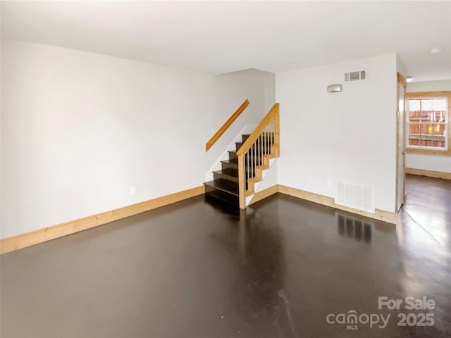 spare room with concrete floors