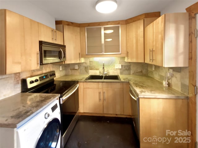 kitchen with decorative backsplash, light brown cabinetry, stainless steel appliances, sink, and washer / dryer