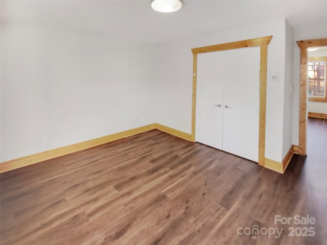 unfurnished bedroom featuring dark hardwood / wood-style flooring