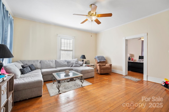 living room with ceiling fan, ornamental molding, and hardwood / wood-style flooring