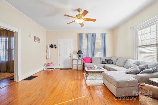 living room featuring wood-type flooring, ceiling fan, and ornamental molding