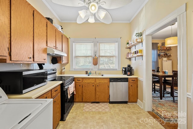 kitchen featuring stainless steel appliances, ceiling fan, sink, pendant lighting, and washer / dryer