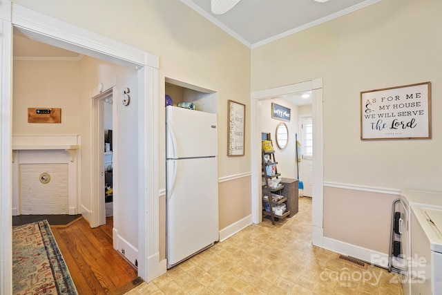 interior space featuring white fridge and crown molding