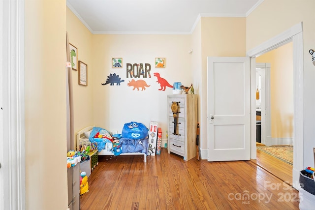 bedroom with crown molding and wood-type flooring