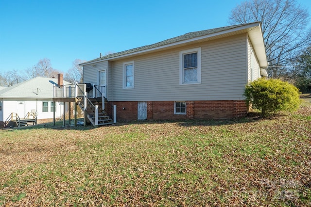 back of property featuring a yard and a deck