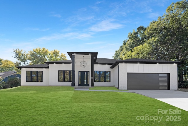 modern home with a garage and a front lawn