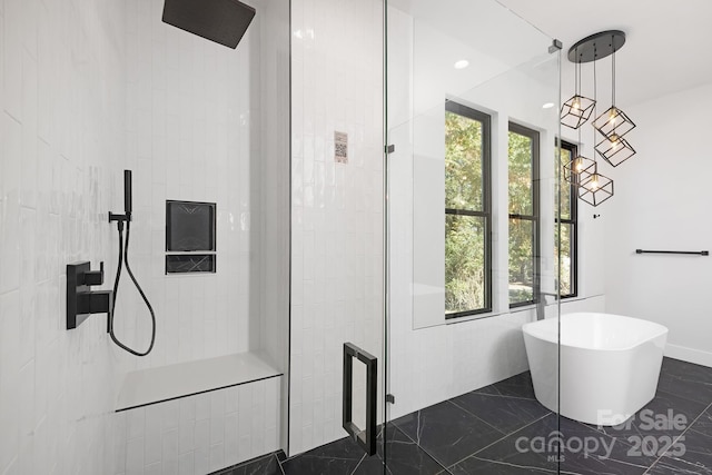 bathroom featuring shower with separate bathtub