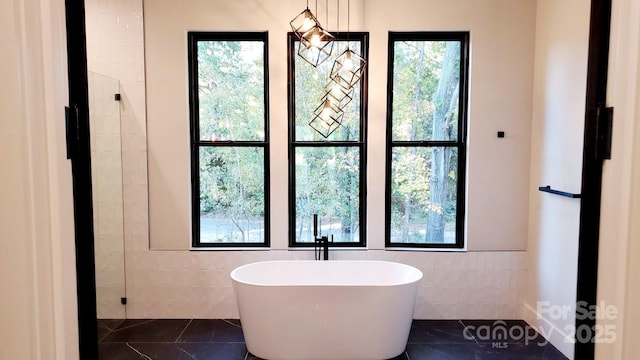 bathroom featuring tile patterned floors and a tub