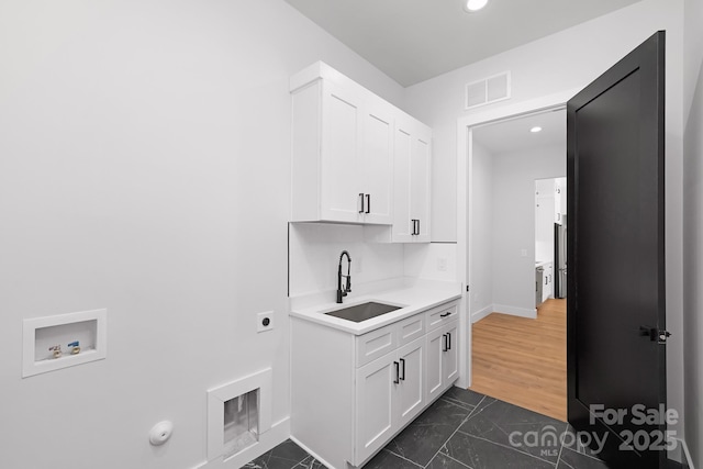 laundry room with sink, cabinets, hookup for an electric dryer, hookup for a gas dryer, and hookup for a washing machine