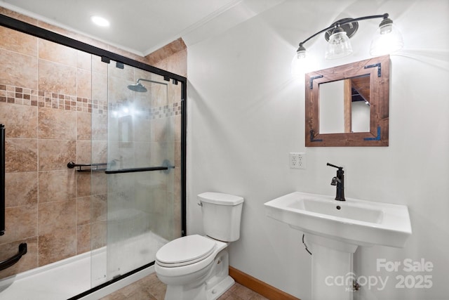 full bathroom with toilet, a stall shower, baseboards, and tile patterned floors