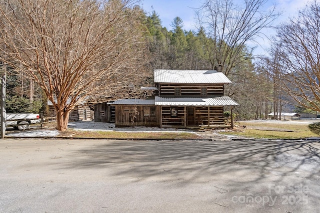 view of front of home featuring an outbuilding and metal roof