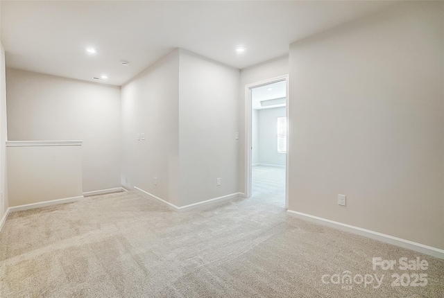 spare room featuring light colored carpet