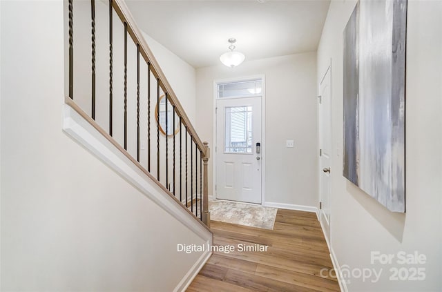 foyer entrance with hardwood / wood-style floors