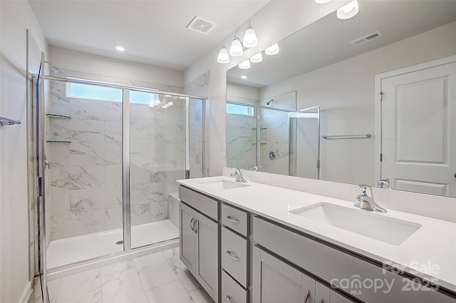 bathroom with vanity and a shower with shower door