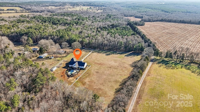 birds eye view of property with a rural view