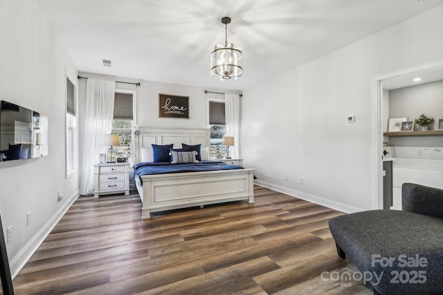 bedroom featuring dark hardwood / wood-style flooring and a notable chandelier