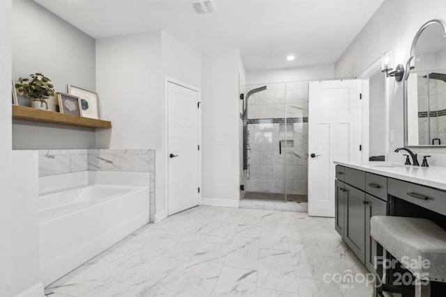 bathroom featuring vanity and independent shower and bath