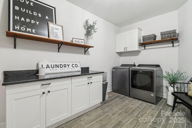 laundry room with washer and clothes dryer and cabinets