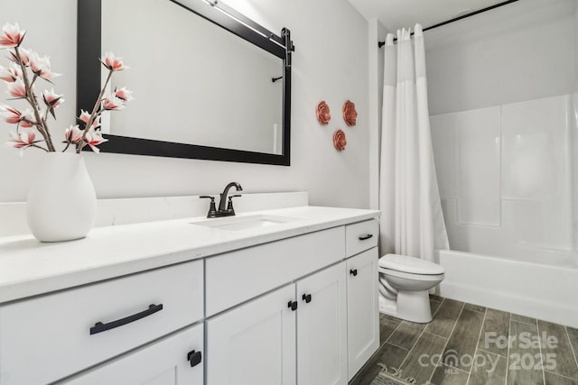 full bathroom with shower / bath combo, vanity, and toilet