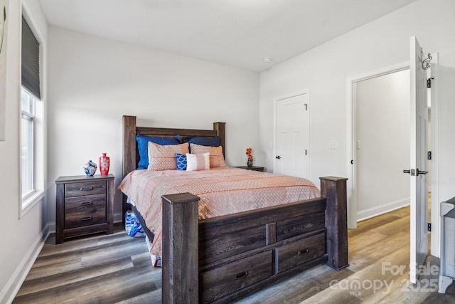 bedroom with hardwood / wood-style flooring