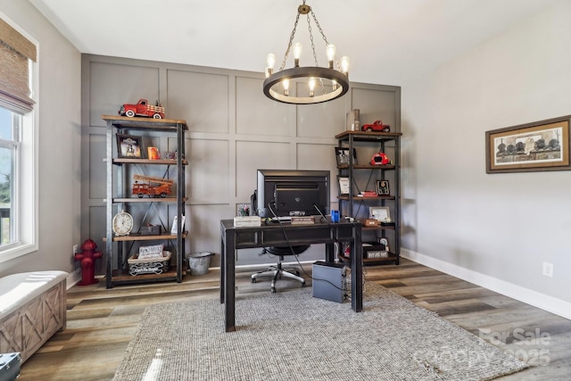 home office featuring a chandelier and hardwood / wood-style flooring