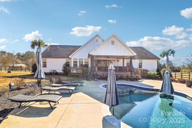 view of pool with a patio area and ceiling fan