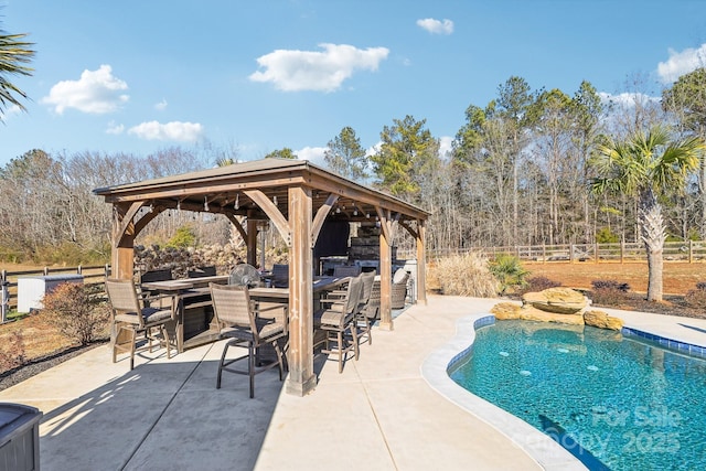 view of swimming pool with a gazebo, a bar, and a patio area