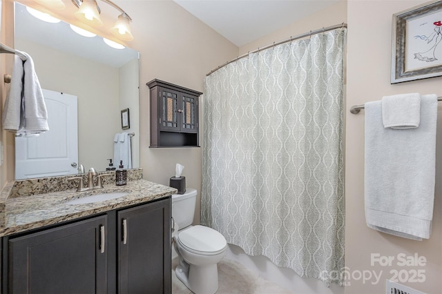 bathroom featuring vanity, walk in shower, and toilet