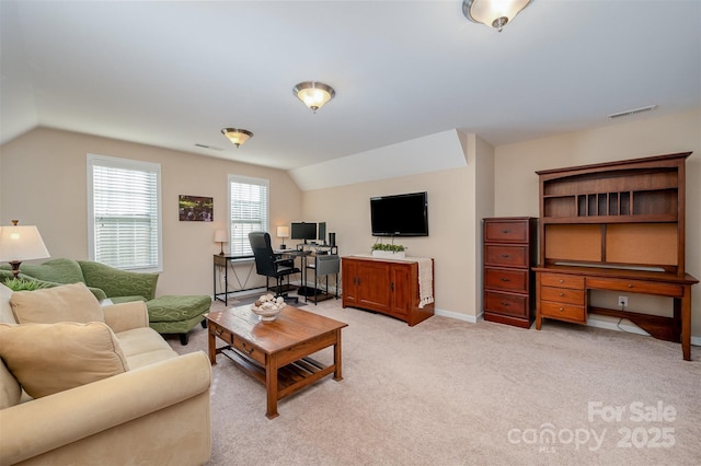 carpeted living room with vaulted ceiling