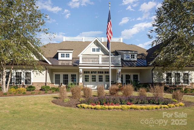 back of house featuring a balcony and a lawn