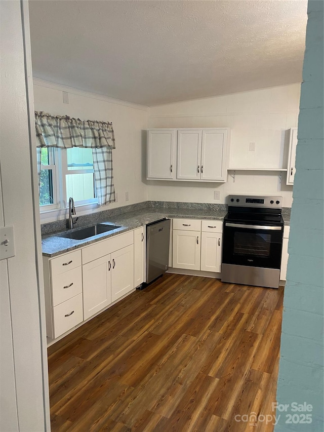 110 Heywood Rd Unit 20, Arden, NC 28704 - kitchen with stainless steel appliances, a sink, dark wood-type flooring, white cabinetry, and dark countertops