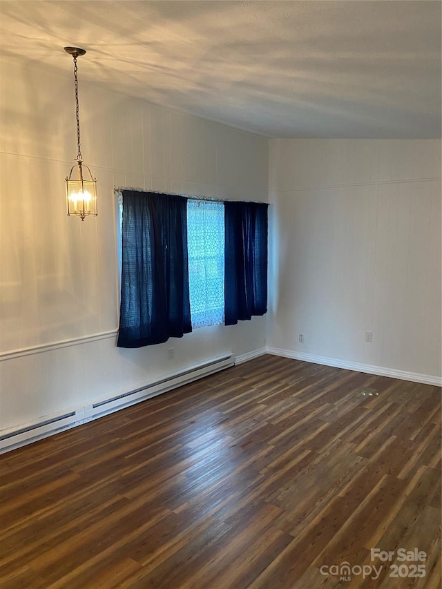 110 Heywood Rd Unit 20, Arden, NC 28704 - unfurnished room featuring a baseboard heating unit, dark wood finished floors, and a chandelier
