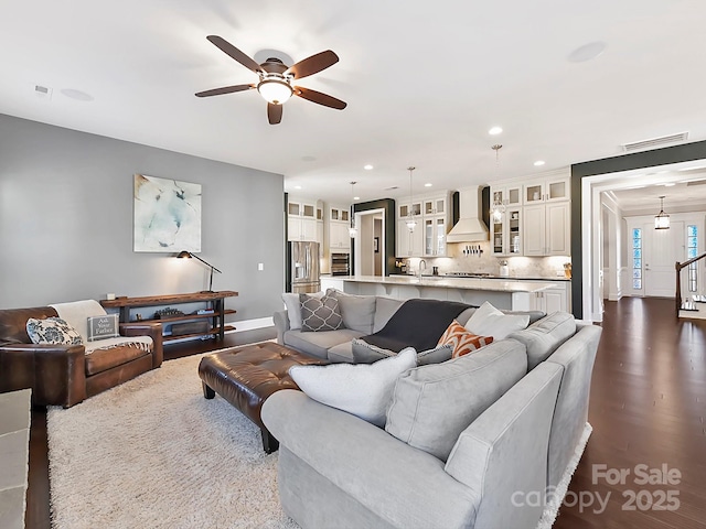 living room with ceiling fan and sink