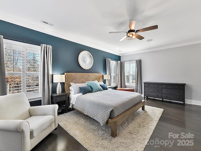 bedroom featuring ceiling fan, dark wood-type flooring, and ornamental molding