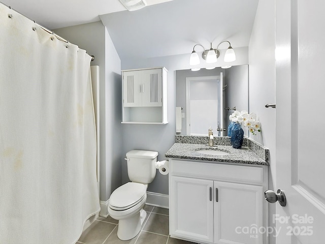 bathroom featuring tile patterned floors, vanity, and toilet