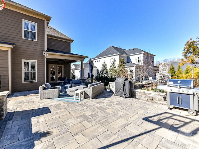 view of patio with outdoor lounge area, a grill, and french doors