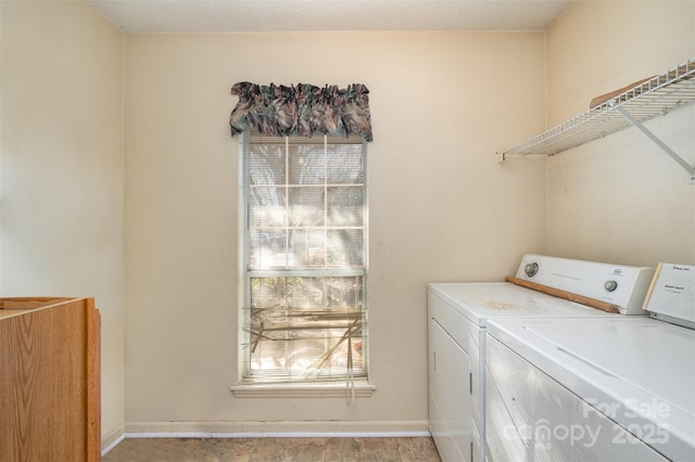 laundry area featuring a wealth of natural light and independent washer and dryer