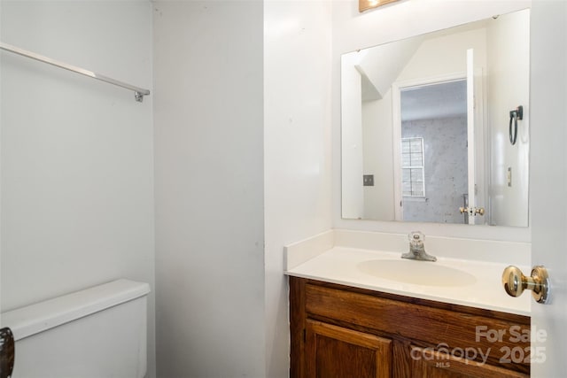 bathroom featuring toilet and vanity