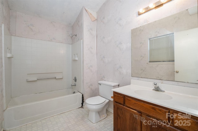 full bathroom featuring toilet, tiled shower / bath combo, and vanity