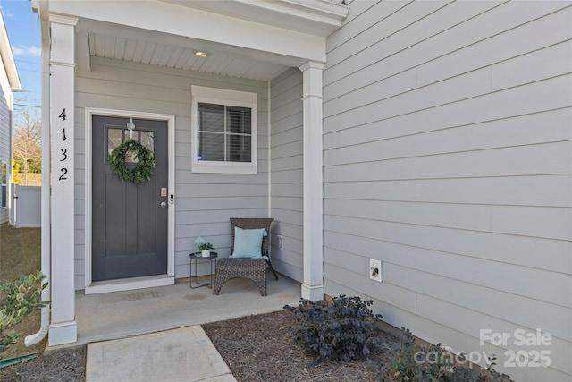 view of exterior entry featuring a porch