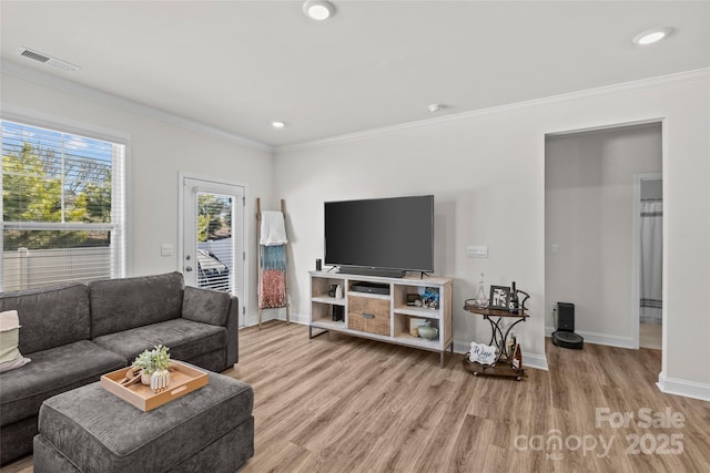 living room with hardwood / wood-style flooring and ornamental molding