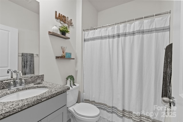 bathroom with a shower with curtain, vanity, and toilet