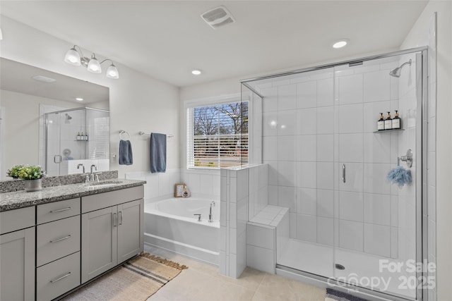 bathroom with tile patterned flooring, shower with separate bathtub, and vanity