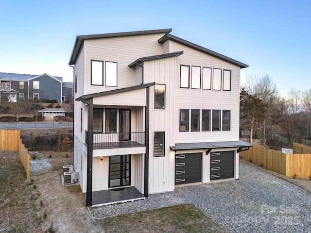 view of front of home featuring central AC unit and a garage