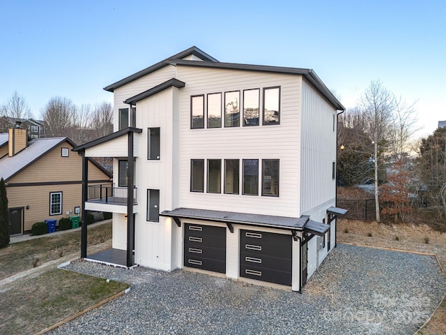 view of front of house featuring a garage and a balcony