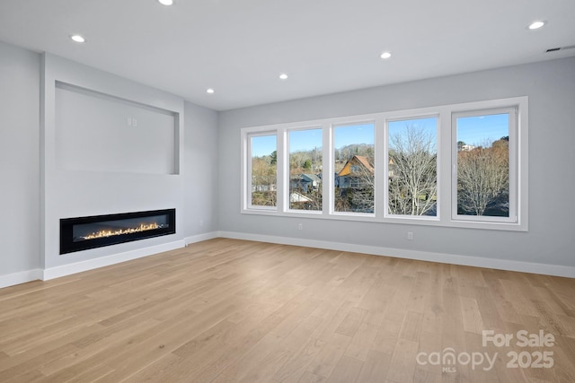 unfurnished living room with light wood-type flooring